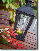 Picture of a candle lanternon a wood table.
